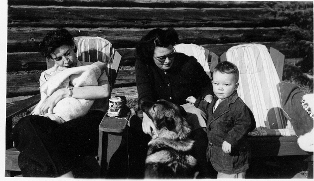 Bets Giddings with Jim Giddings, Rayder the Norwegian Elkhound, and Lil Turner holding Ann Giddings in 1949